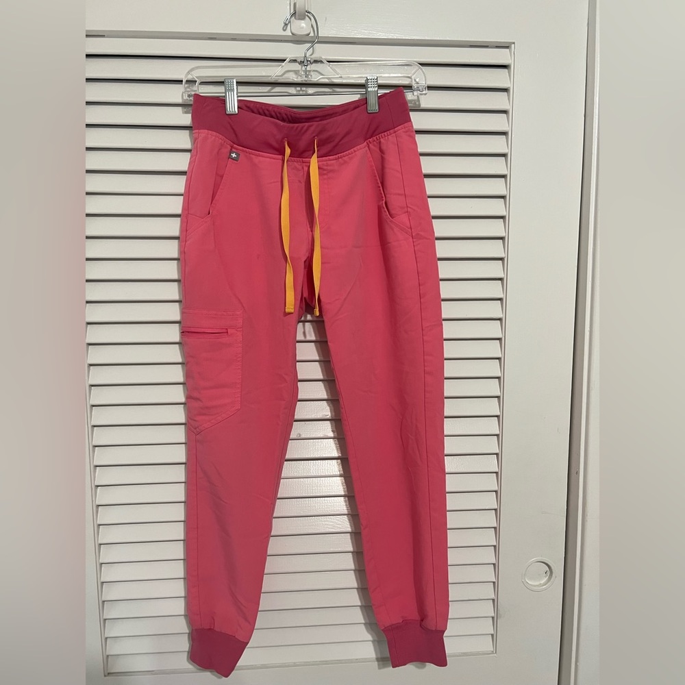 FIGS jogger scrub pants. Pink with yellow/orange ties.